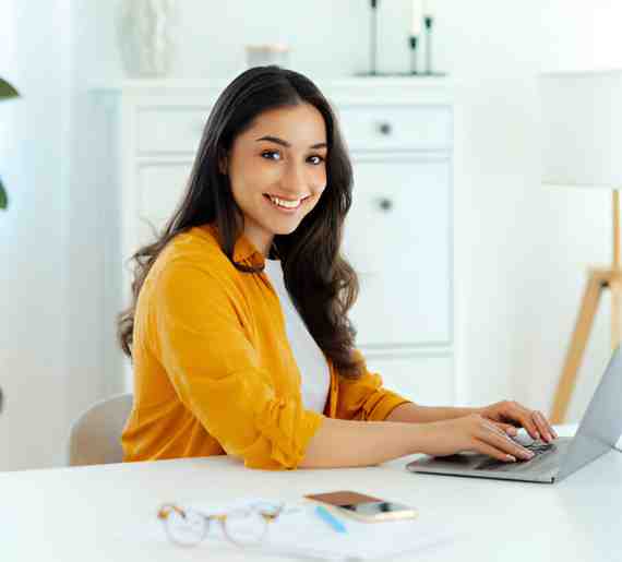 Woman doing E-commerce SEO work on laptop